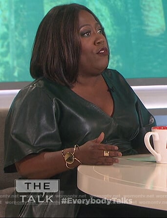 Sheryl’s green leather v-neck top on The Talk