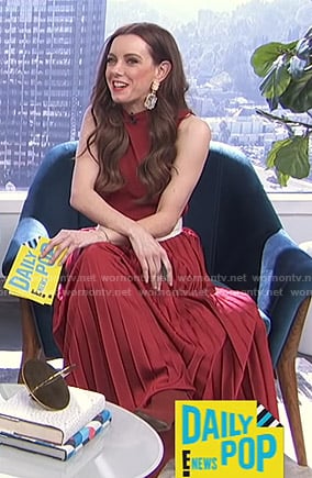 Melanie’s red pleated sleeveless dress on E! News Daily Pop