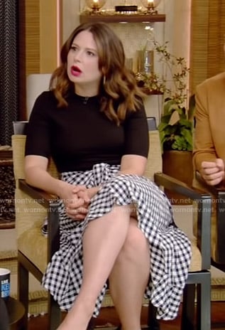 Katie Lowes’s black top and gingham check skirt on Live with Kelly and Ryan