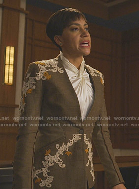 Lucca's twist neck blouse and plaid blazer with applique on The Good Fight