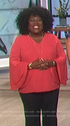 Sheryl’s pink tiered bell sleeve top on The Talk