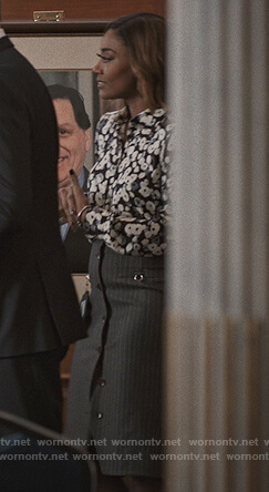 Daisy's black floral blouse and stripe skirt on Madam Secretary