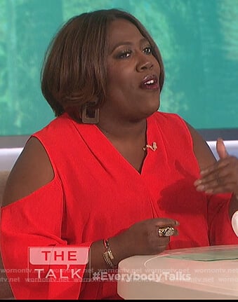 Sheryl’s red cold shoulder top on The Talk