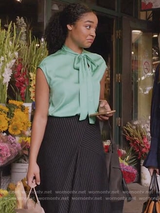 Kat's green tie neck top and pinstripe skirt on The Bold Type