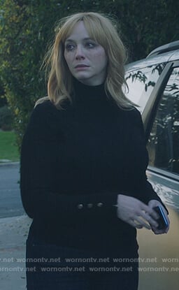 Beth’s black turtleneck top with button cuffs on Good Girls