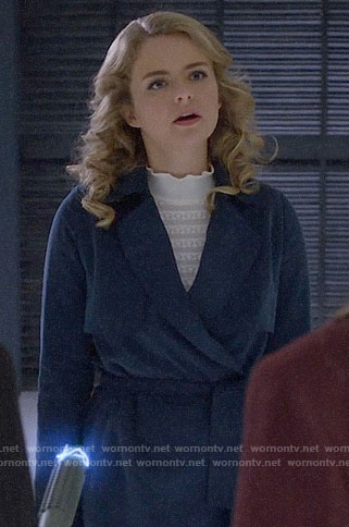 Eve's blue trench coat and white ruffle neck sweater on Supergirl
