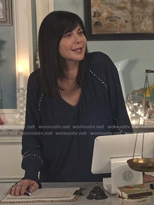 Cassie’s navy studded v-neck top  on Good Witch