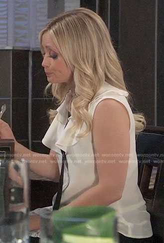 Lulu’s white ruffled top with black tie neck on General Hospital