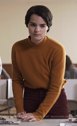 Elodie’s orange sweater on Trinkets