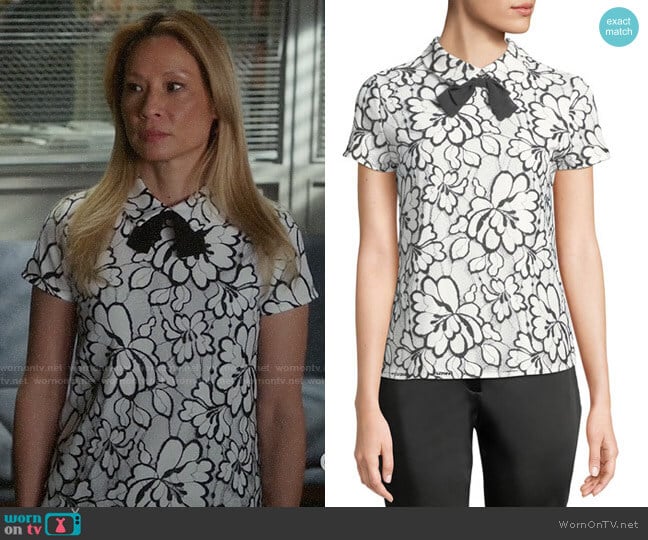 Karl Lagerfeld Floral Lace Short-Sleeve Bow Tie Top worn by Joan Watson (Lucy Liu) on Elementary