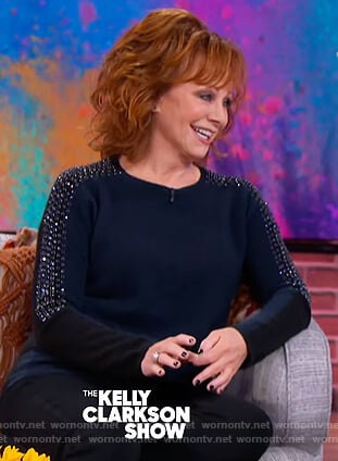 Reba McEntire’s navy embellished sleeve sweater on The Kelly Clarkson Show