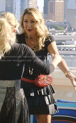 Kary's leather pleated mini skirt and red belt bag on The Real Housewives of Dallas