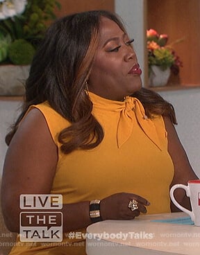 Sheryl’s yellow sleeveless tie neck top on The Talk