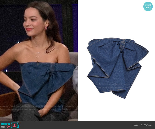 Adeam Cropped strapless bow-detailed denim top worn by Natalia Reyes on A Little Late with Lilly Singh