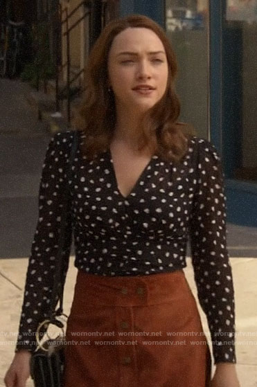 Cara's black spotted top and suede button-front skirt on God Friended Me