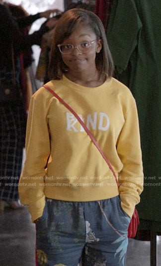 Diane's yellow BE KIND sweatshirt and floral pants on Black-ish