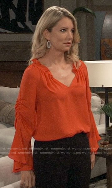 Nina’s orange ruffle neck blouse on General Hospital