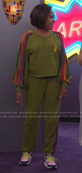 Tina’s green sweatshirt with rainbow striped sleeves on The Neighborhood