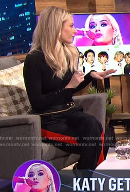 Morgan’s black sweater and side striped pants on E! News Nightly Pop