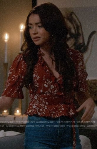 Haley's red floral wrap top on Modern Family