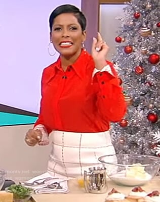 Tamron’s red contrast cuff shirt and check skirt on Tamron Hall Show