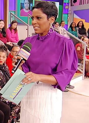 Tamron’s purple blouse and fringe skirt on Tamron Hall Show