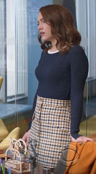 Cara's navy ribbed sweater and checked button front skirt on God Friended Me