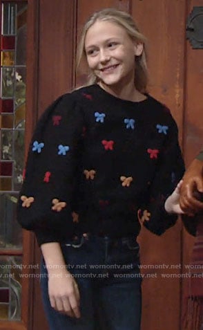 Faith's black sweater with multi color bows on The Young and the Restless