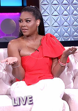 Kenya Moore’s red one shoulder bow top on The Real