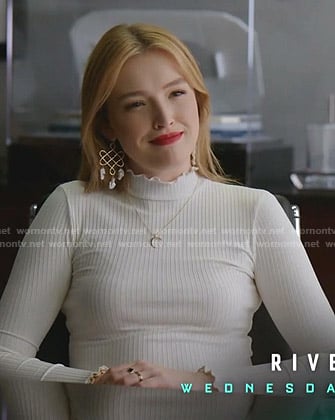 Kirby's white ruffle mock neck top and check pants on Dynasty