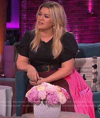 Kelly's pleated skirt and black puff sleeve top on The Kelly Clarkson Show