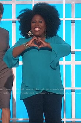 Sheryl’s turquoise ruffle hem blouse on The Talk