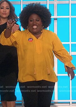 Sheryl’s yellow tassel tie blouse on The Talk