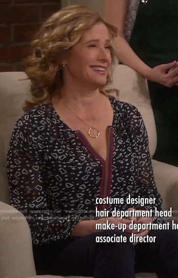 Vanessa's black printed split-neck top on Last Man Standing