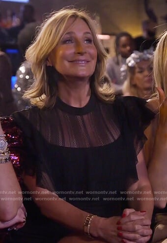 Sonja’s black sheer ruffle dress and bow earrings on The Real Housewives of New York City