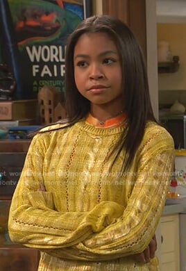 Nia's metallic yellow cable knit sweater on Ravens Home