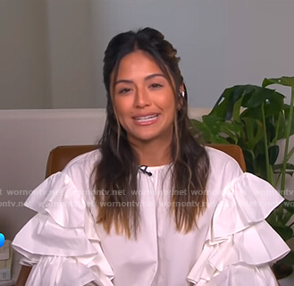 Erin's white ruffle-sleeve blouse on E! News Daily Pop