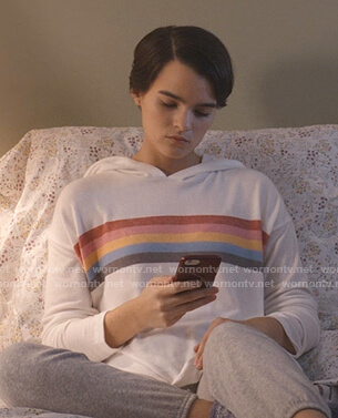 Elodie’s white rainbow striped hoodie on Trinkets