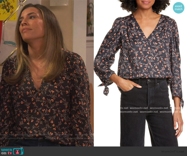 Jo’s black floral v-neck top on United We Fall