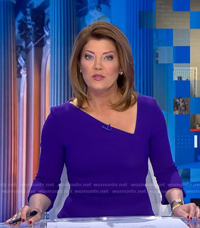 Norah’s blue asymmetric v-neck dress on CBS Evening News