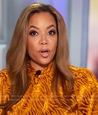 Sunny's orange metallic blouse on The View