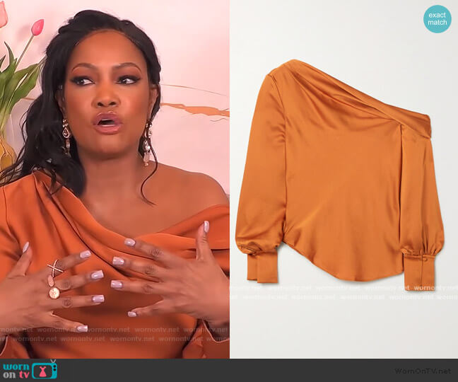 Alice draped one-shoulder satin blouse by Jonathan Simkhai worn by Garcelle Beauvais on The Real