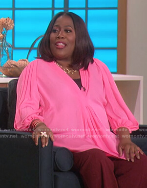 Sheryl’s pink pleated top on The Talk