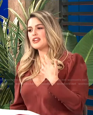 Carissa’s red v-neck puff sleeve top on E! News Daily Pop