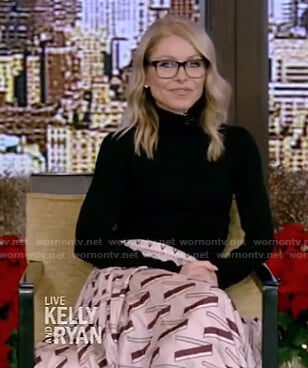 Kelly's black sweater and pink print pleated skirt on Live with Kelly and Ryan