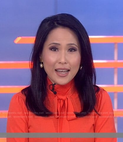 Vicky’s orange tie neck knit top on Today