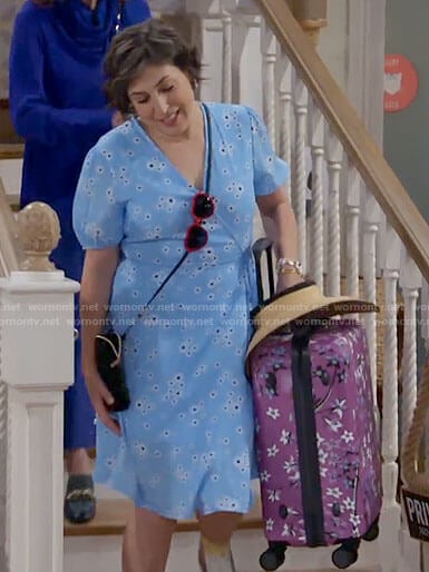 Kat's blue floral wrap dress and purple suitcase on Call Me Kat