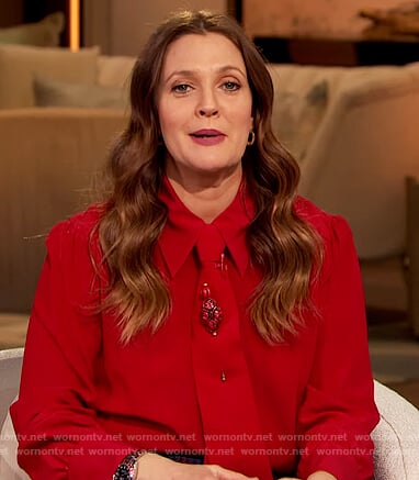 Drew’s red tie neck blouse and plaid pants on The Drew Barrymore Show