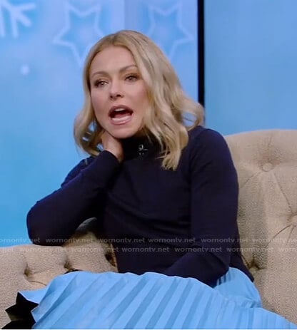 Kelly’s navy sweater and blue pleated skirt on Live with Kelly and Ryan