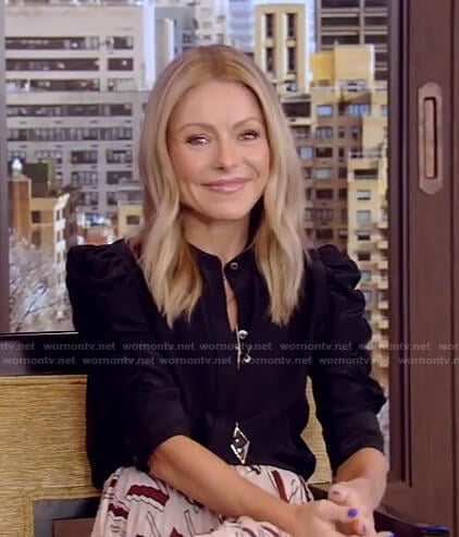 Kelly’s black puff sleeve blouse and print pleated skirt on Live with Kelly and Ryan